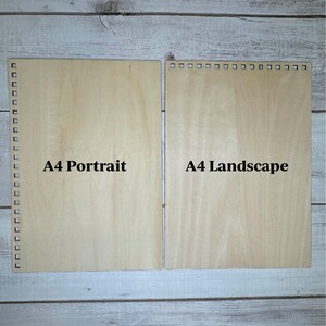 May include: Two pieces of unfinished wood, one labeled "A4 Portrait" and the other labeled "A4 Landscape".