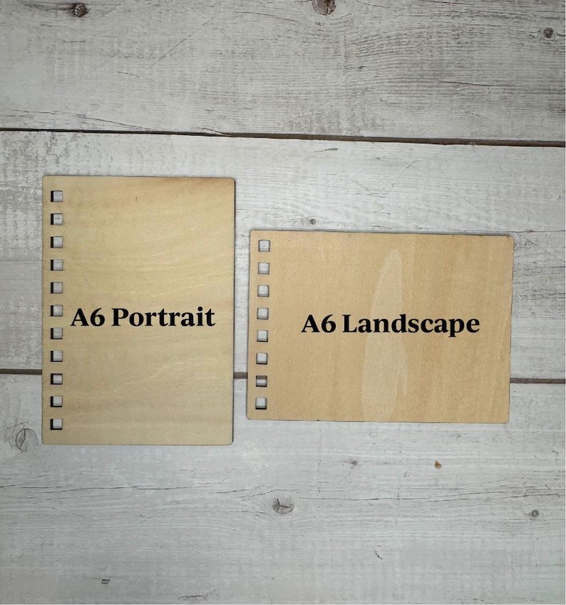 May include: Two pieces of wood, one labeled "A6 Portrait" and the other "A6 Landscape".