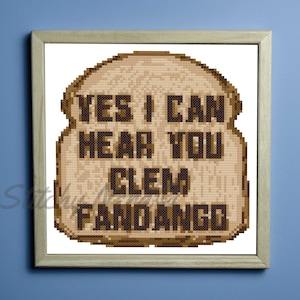 May include: A brown and tan cross-stitch design of a slice of bread with the text "YES I CAN HEAR YOU CLEM FANDANGO" on it.