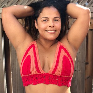 K&ouml;nnte beinhalten: Ein rotes und pfirsichfarbenes H&auml;kel-Halter-Top mit tiefem V-Ausschnitt und einem gewellten Saum.