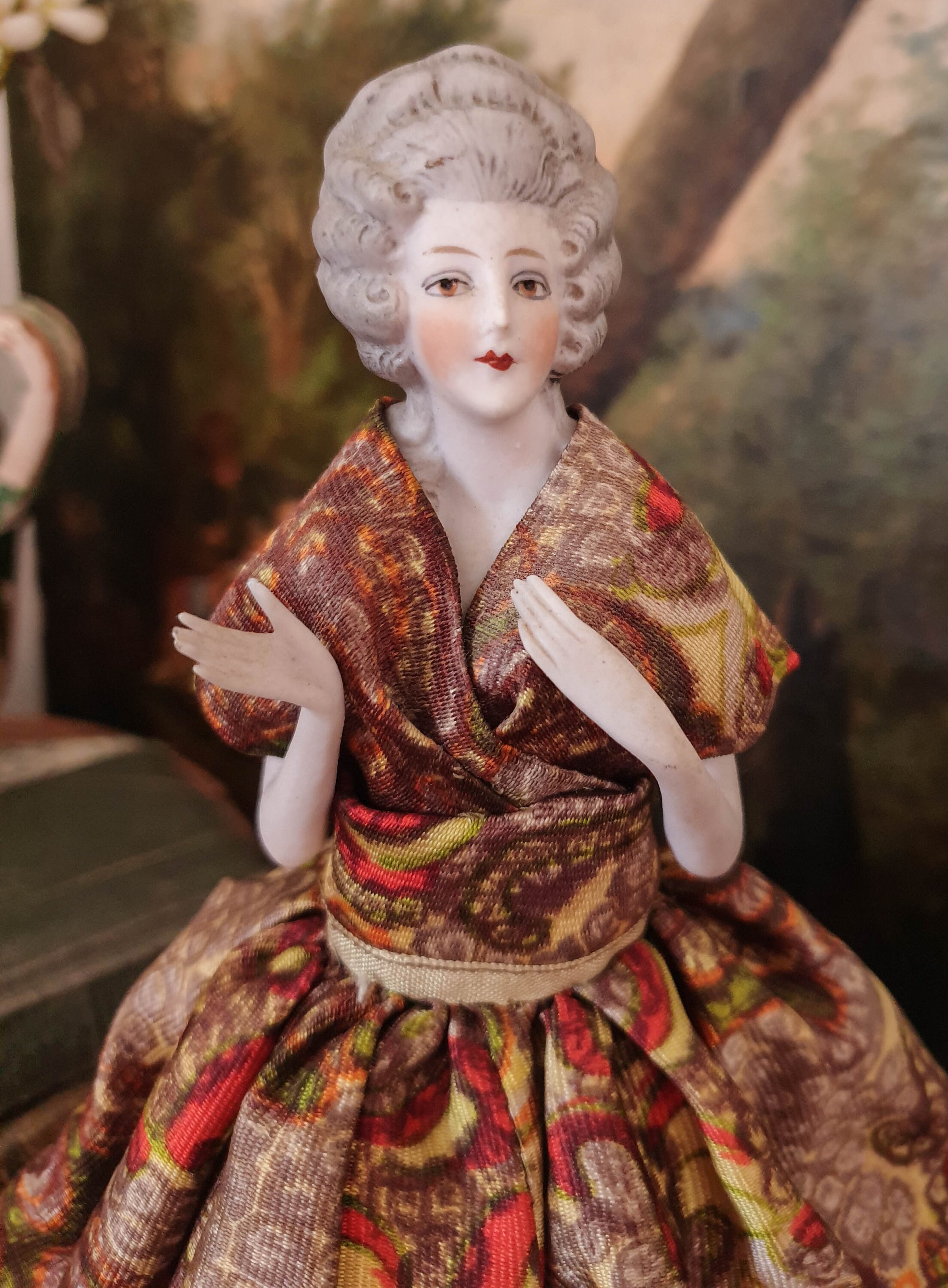 antique French half doll with porcelain half body and green and gold dress