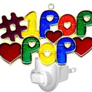May include: A colorful night light with the words "#1 Pop" and hearts. The letters are outlined in gold and have a glittery finish. The night light plugs into a standard outlet.
