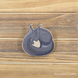 May include: A wooden cutout of a curled up, sleeping, gray-blue squirrel. The squirrel is curled up in a circle with its tail wrapped around its body.