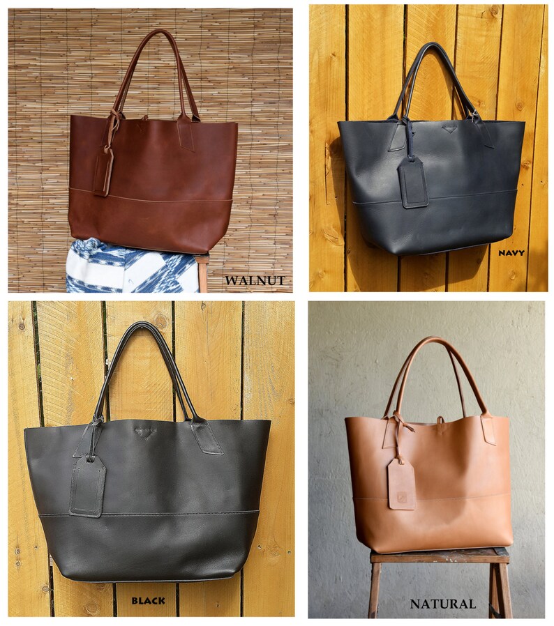 May include: Four leather tote bags in different colors: walnut, navy, black, and natural. Each bag has a single strap and a small leather tag.