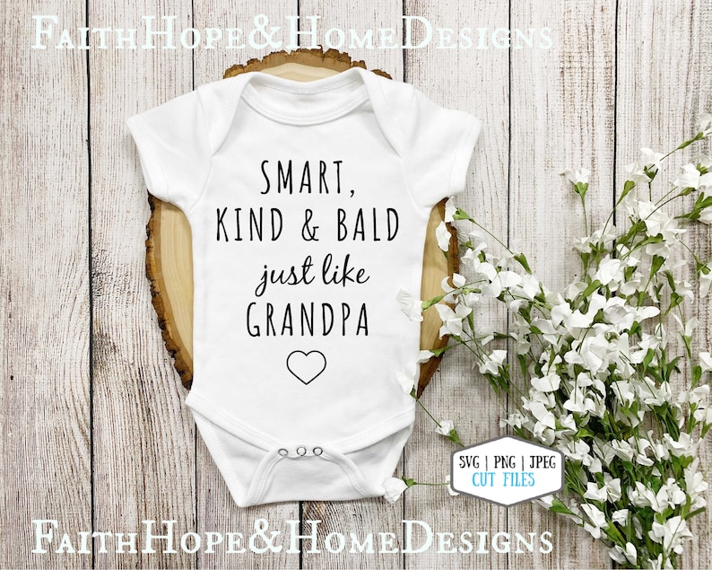 May include: White baby bodysuit with black text that reads "SMART, KIND & BALD just like GRANDPA" with a heart symbol.