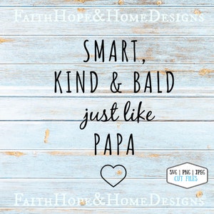 May include: A woodgrain background with a black text overlay that reads "SMART, KIND & BALD just like PAPA" with a heart shape below the text. The text is a design for a cut file.