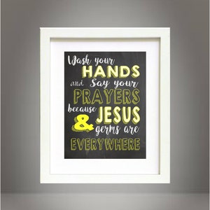 May include: A framed chalkboard sign with the text "Wash your HANDS and Say your PRAYERS because JESUS & germs are EVERYWHERE" in white chalk with yellow accents.