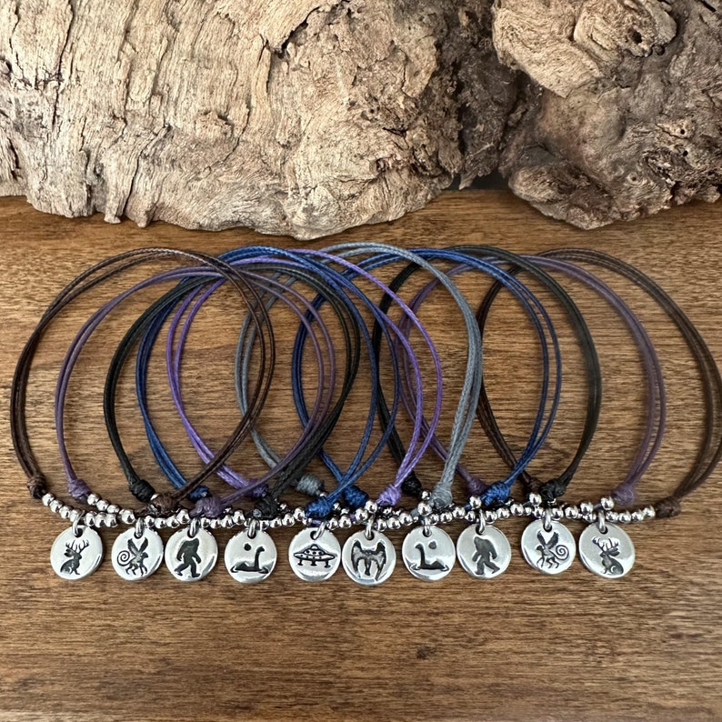 Mythical SciFi Bracelet - Big Foot Mothman Waterproof Adjustable Cord Charm Bracelet - UFO Jackalope Loch Ness Monster Nerdy Cryptid Lover - Handcrafted Unique Silver Charms with Sasquatch Bigfoot hand stamped for men women and children