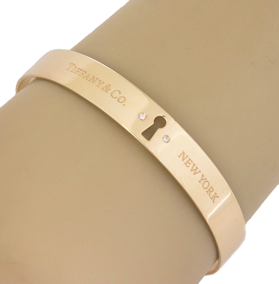 27645 - Tiffany & Co. 18k Yellow Gold Diamond Keyhole Lock Bangle