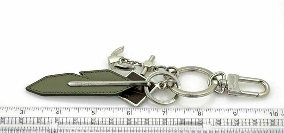 22293 - Louis Vuitton Silver Tone Leather Monogram Bag Charms Key