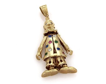 May include: A gold-toned pendant featuring a detailed clown figurine with colorful gemstones. The clown is wearing a hat and has a playful expression.