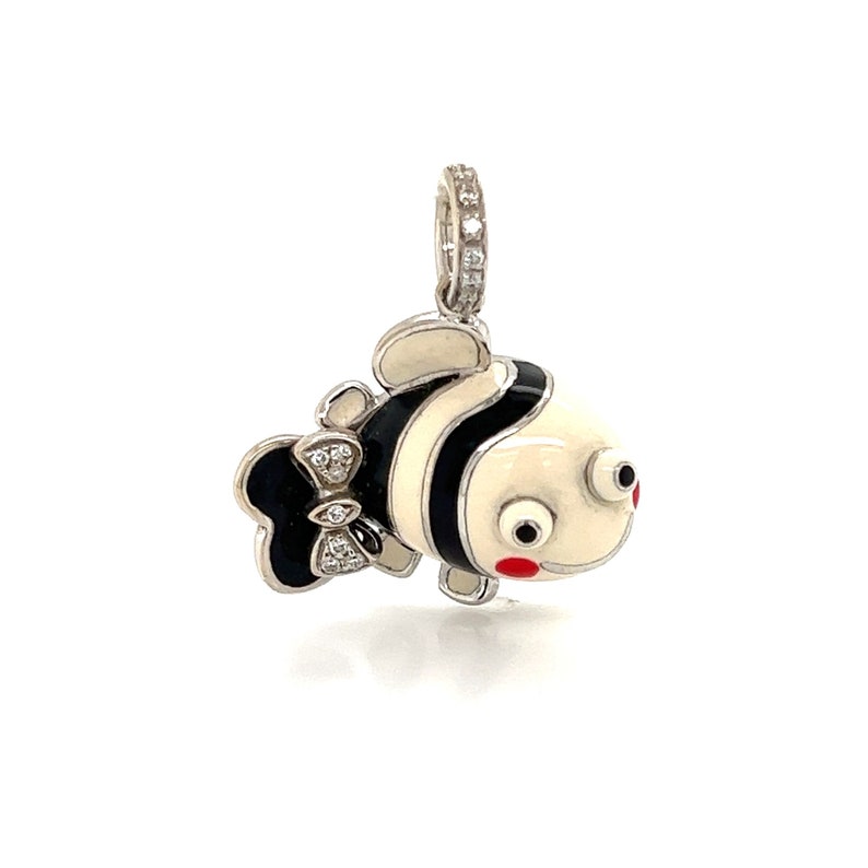 May include: A white and black enamel fish charm with a red mouth and white eyes. The fish has a black bow with diamonds on it. The charm is made of silver and has a diamond halo around the bail.