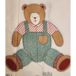 May include: A pattern for a brown teddy bear wearing blue overalls with a red and white checkered shirt. The pattern includes instructions for cutting, sewing, and stuffing the bear.