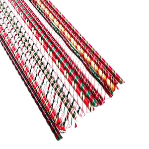 May include: A collection of striped candy canes in various colors, including red, green, and white. The candy canes are arranged diagonally against a white background, showcasing their festive appearance. The image highlights the traditional holiday treat.