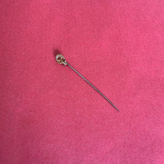 XIX’s tie pin.