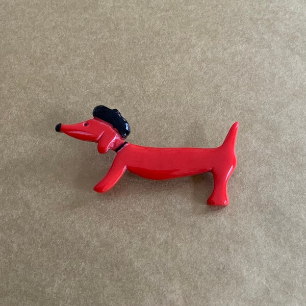 Broche « chien » rouge.