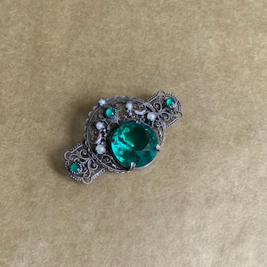 French big metal and green crystal brooch.