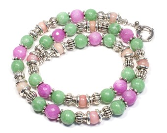 May include: A multi-strand necklace featuring green, pink and light pink jade beads with silver spacer beads.