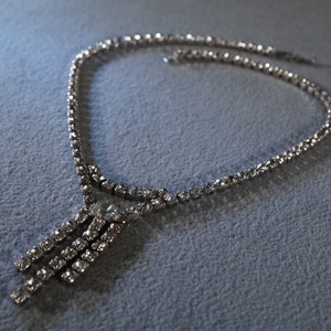 vintage silver tone bib style necklace with all prong set rhinestones and three dangling banners of rhinestones     M