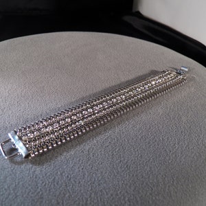 Vintage silver tone serpentine bracelet with a row of white rhinestones                 M
