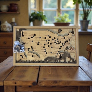 May include: Wooden framed map of the United States with laser-cut state outlines. The map has numerous black pins marking locations. A small bag of round tokens sits in the corner. The bottom of the map features animal silhouettes and the text "ZOO MIGHTY LIST".