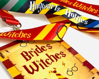 May include: A collection of colorful lanyards and a matching card featuring text and graphics. The lanyards have stripes in various colors, including red, green, and yellow, with the words "Hogwarts" and "Brides Witches" printed on them. The card has a parchment-like appearance with the words "Brides Witches".