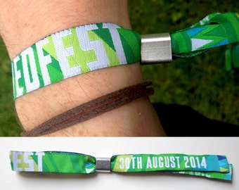 May include: Green, blue, and white wristbands with the text "WEDFEST" and "DISH AND ANNA" printed on them. The wristbands have a silver clasp.