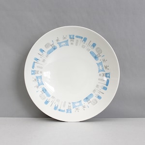 May include: White ceramic serving bowl with a blue and gray geometric pattern around the rim. The bowl has a wide, shallow design, suitable for serving salads or pasta dishes. The pattern features stylized shapes.