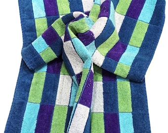 May include: A blue, green, purple, and white checkered bath towel with fringe. The towel is folded with a matching robe. The colors are arranged in a grid pattern. The fringe is a darker shade of blue.
