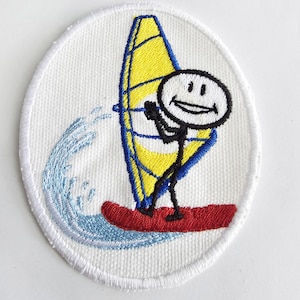 May include: Embroidered patch featuring a stick figure windsurfing. The design includes a yellow sail with blue accents, a red board, and a blue wave. The patch is oval-shaped with a white background and border.