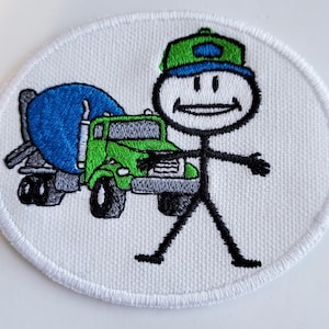 May include: A white embroidered patch with a stick figure wearing a green and blue hat standing next to a green cement truck.