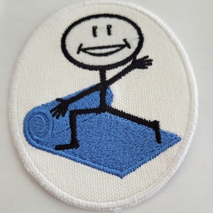 May include: White embroidered patch with a stick figure smiling and holding a blue yoga mat.