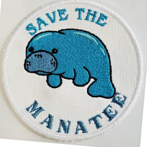 May include: White embroidered patch with a blue manatee and the text "Save the Manatee" in a circle.