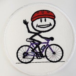May include: A white embroidered patch with a stick figure wearing a red helmet riding a purple bicycle. The stick figure is waving with a smile.