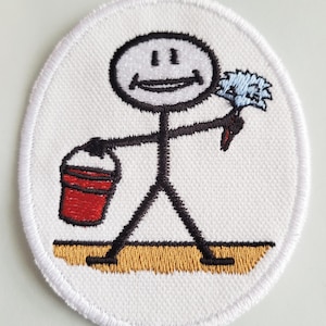 May include: A white embroidered patch with a stick figure holding a bucket and a duster. The stick figure is smiling and has a red bucket and a blue duster.