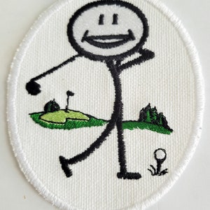 May include: Embroidered patch of a stick figure golfer on a green golf course with a white background. The golfer is smiling and holding a golf club. The patch is circular with a white border.