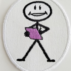 May include: White embroidered patch with a stick figure holding a purple rectangle. The stick figure has a smiling face.