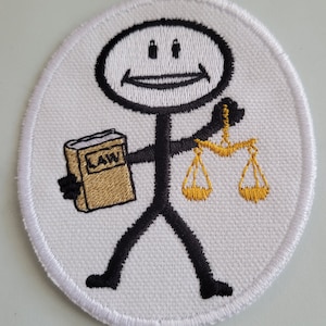 May include: White embroidered patch with a stick figure holding a book that says "LAW" and a scale of justice.