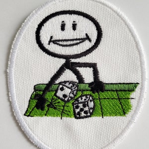 May include: A white embroidered patch with a stick figure smiling and rolling dice on a green game board.