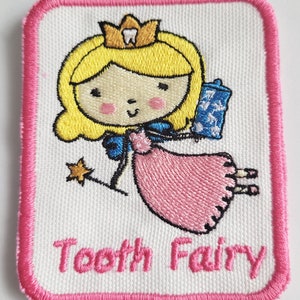May include: Embroidered patch featuring a cartoon tooth fairy with a pink dress, a blue sash, and a crown. The text "Tooth Fairy" is embroidered below the fairy.