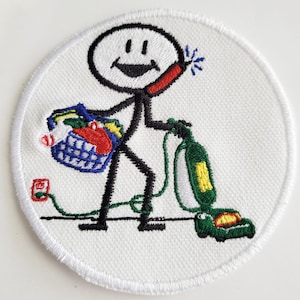 May include: A white embroidered patch with a stick figure holding a vacuum cleaner, a basket of groceries, and a phone. The stick figure is smiling and has a happy expression.