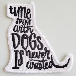 May include: White embroidered patch shaped like a dog with the text "time spent with dogs is never wasted".