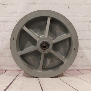 May include: A handmade wooden sign with the text "Welcome" in a playful font. The sign is painted white with a distressed finish, and features a decorative floral design in shades of pink and green. It measures approximately 12 inches wide.