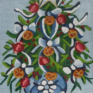 May include: Needlepoint design of a festive arrangement in a blue vase. The arrangement features green foliage, red and orange ornaments, white ribbons, and a gold star at the top. The vase has a floral pattern.