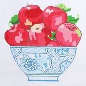 May include: A blue and white ceramic bowl filled with red apples. The bowl has a floral design and a geometric pattern.
