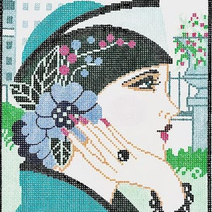 May include: Needlepoint art of a woman in profile, wearing a black hat adorned with pink and blue floral accents. She holds a blue flower, with a black beaded necklace. The background features a cityscape and floral elements.