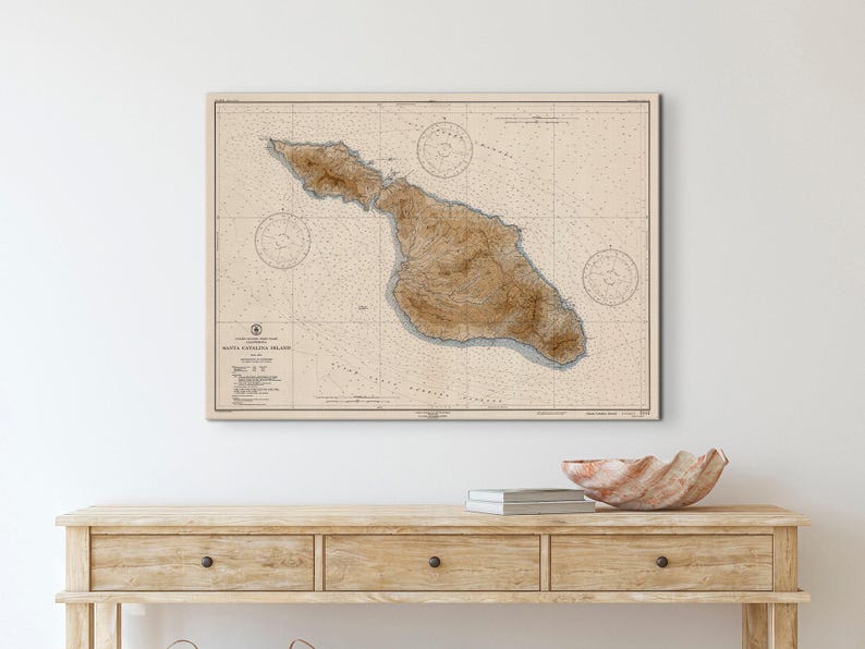 Vintage Nautical chart of Santa Catalina Island hung on a wall above a wooden console table.