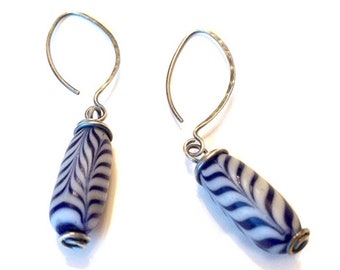 Blue and white feather pattern glass trade bead earrings with hammered and textured marquise ear wires