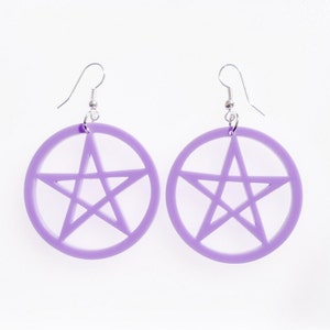 May include: A pair of purple earrings with a pentagram design. The earrings are made of acrylic and have silver hooks.