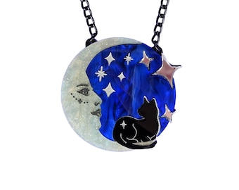 May include: A crescent moon pendant necklace with a black cat silhouette and silver glitter stars on a blue background.